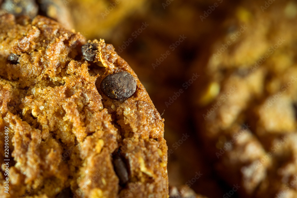 Fototapeta premium Chocolate chip cookies on rustic dark black background. Stacked 