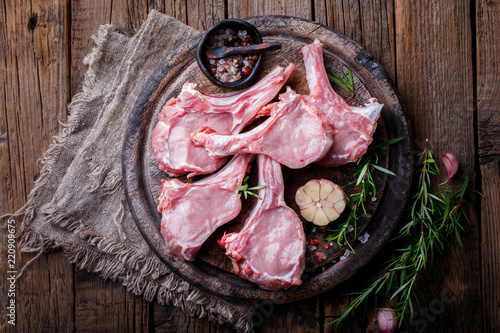 Schilderij op canvas Raw fresh meat Veal rib Steak on bone and meat fork  on a wooden vintage backgro