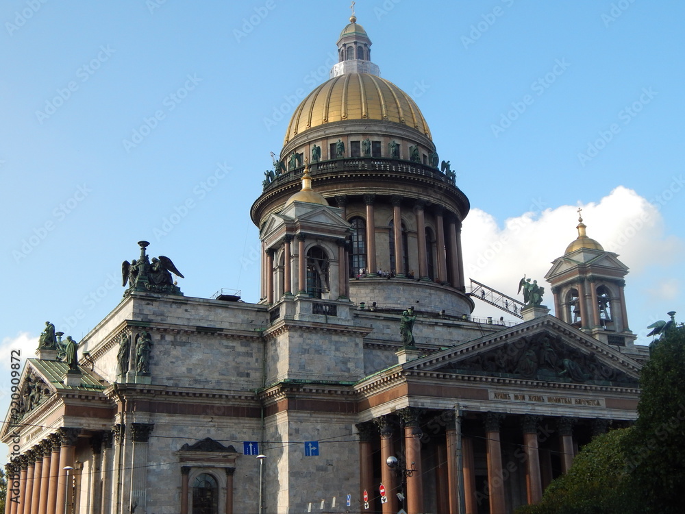 The golden dome of St. Isaac's Cathedral in St. Petersburg against the blue sky