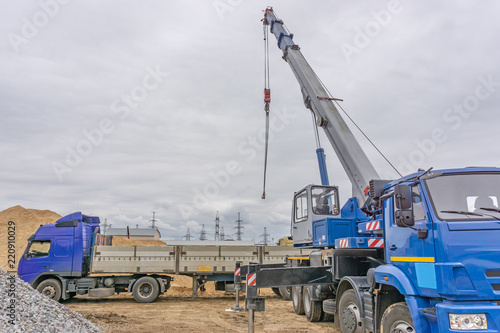 Unloading of building materials by crane at the construction site