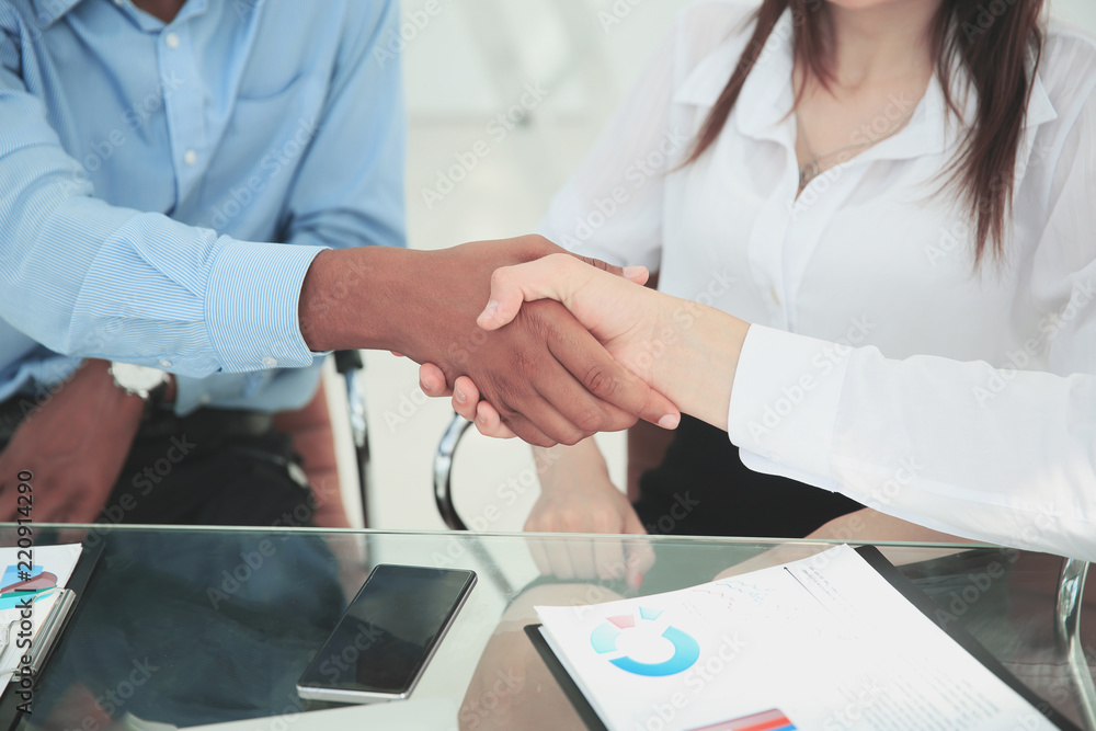 closeup.the financial partners shaking hands over a Desk. closeup.the financial partners shaking hands over a Desk.