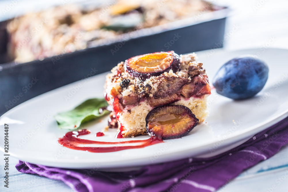 The traditional sweet plum cake on white plate The traditional sweet plum cake on white plate