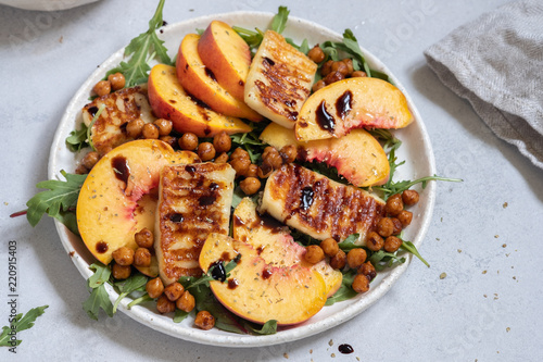 Green salad with grilled halloumi cheese and peaches