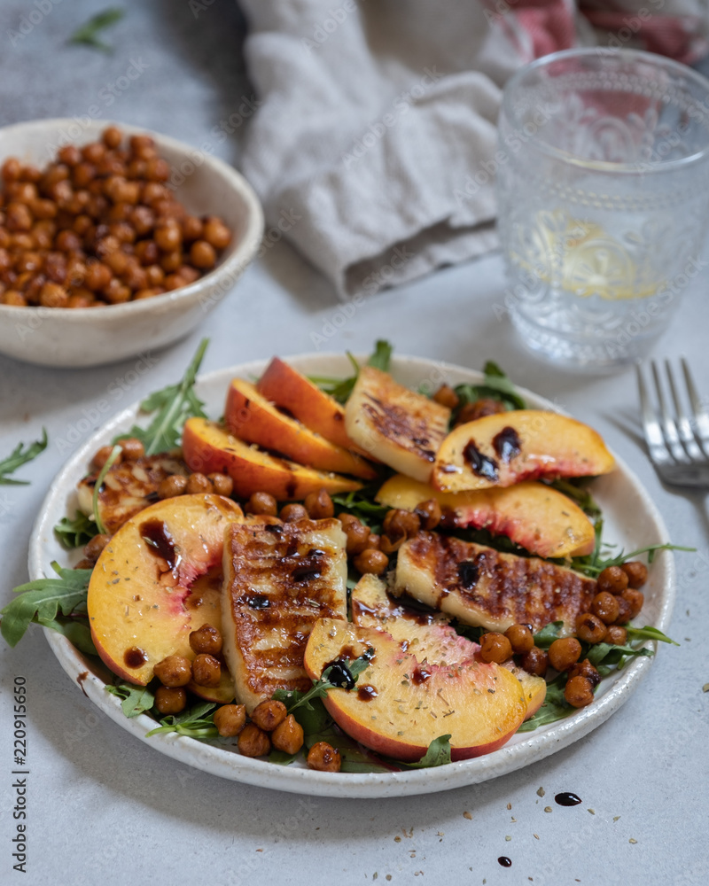 Green salad with grilled halloumi cheese and peaches