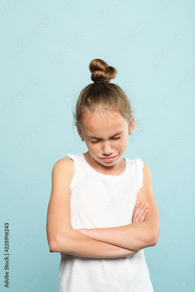 disappointed sad crying little girl. emotion expression and feelings concept. offended hurt young child portrait on blue background. disappointed sad crying little girl. emotion expression and feelings concept. offended hurt young child portrait on blue background.