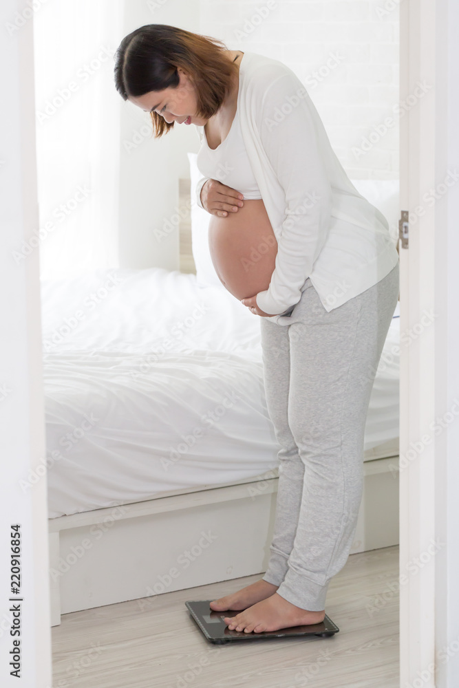 Pregnant women are weighing for weight gain during pregnancy, Eight month Pregnant women are weighing for weight gain during pregnancy, Eight month