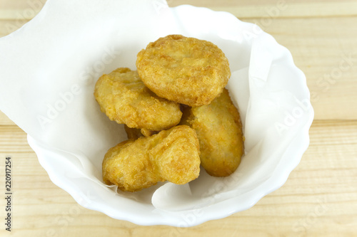 Chicken nuggets in white cup on wooden background,copy space.