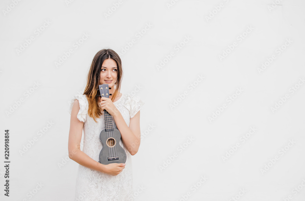 Young smiling beautiful woman with ukulele Young smiling beautiful woman with ukulele