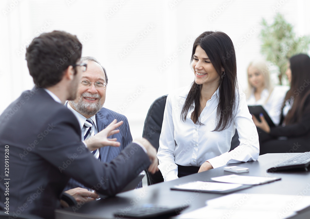 project Manager and staff talking at the Desk project Manager and staff talking at the Desk