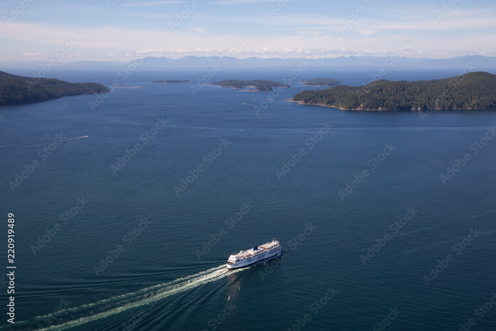 Aerial view of a ferry boat traveling in Howe Sound during a sunny summer day. Taken North of Vancouver, BC, Canada. Aerial view of a ferry boat traveling in Howe Sound during a sunny summer day. Taken North of Vancouver, BC, Canada.