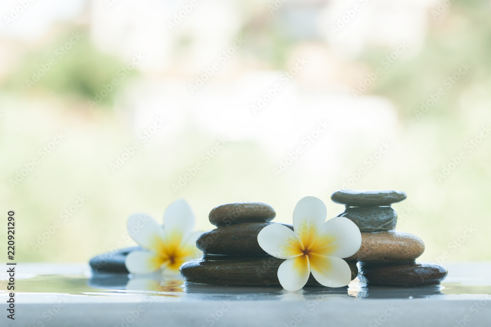 Two sets of spa objects for massage treatment on white table outdoors Two sets of spa objects for massage treatment on white table outdoors