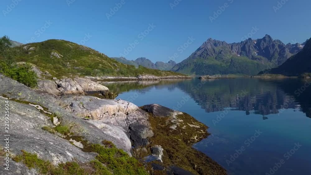 The drone is flying through a tent located on the shore of the Norwegian fjord. Adventure and travel concept. Lofoten Islands. 4K