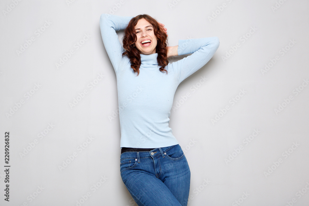 young woman laughing with hands behind head young woman laughing with hands behind head