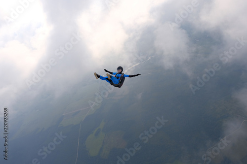 Fototapeta Naklejka Na Ścianę i Meble -  Skydiving. Girl is in the sky.