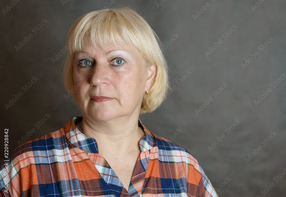 Portrait of middle aged woman on dark background. Portrait of middle aged woman on dark background.