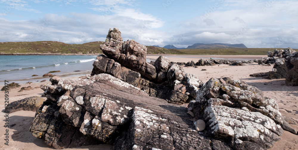 Achnahaird Beach in Wester Ross, Scottish Highlands. Quiet, cresent shaped beach on the north west coast of Scotland, with mountains in the background.