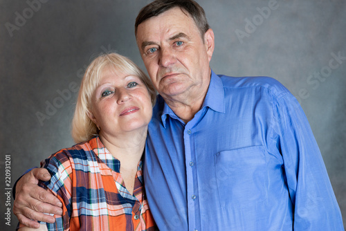 Seniors couple portrait on dark background.