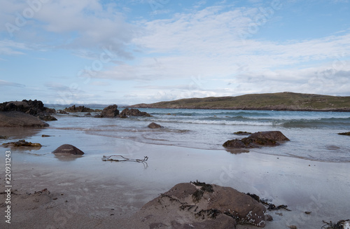 Achnahaird Beach in Wester Ross, Scottish Highlands. Quiet, cresent shaped beach on the north west coast of Scotland, with mountains in the background.