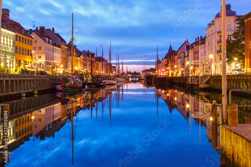 Photography Panorama of Nyhavn with colorful facades of old houses and old ships in the Old Town of Copenhagen, capital of Denmark