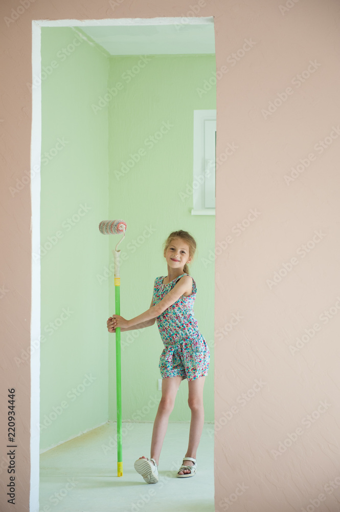 beautiful art girl with paint roller in doorway of new room in home house beautiful art girl with paint roller in doorway of new room in home house