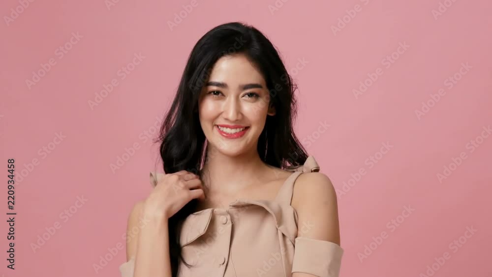 Attractive woman with happy emotion at pink background. People emotion concept. 4k resolution. Attractive woman with happy emotion at pink background. People emotion concept. 4k resolution.