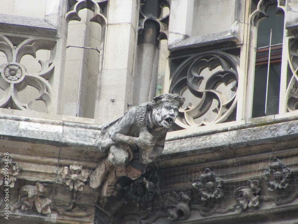 Statues of mythological creatures, chimeras, gargoyles and others on the walls of ancient buildings