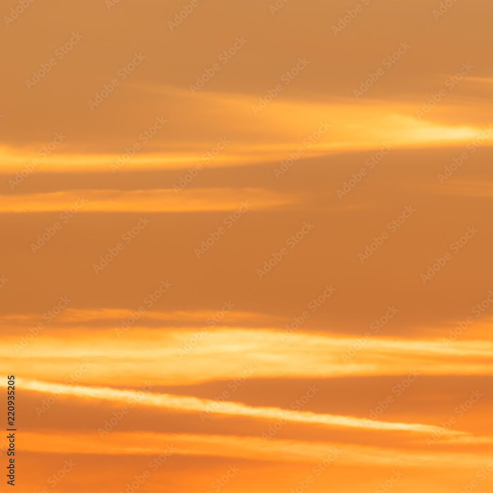 Squared image of beautiful sunset sky with soft clouds. Orange, pastel tone
