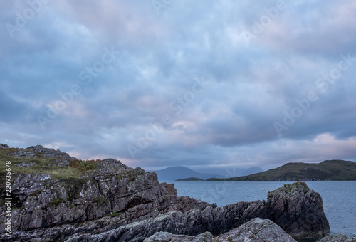 Summer Isles at dusk, taken from the UK mainland, north of Polbain on the west coast of Scotland.  photo