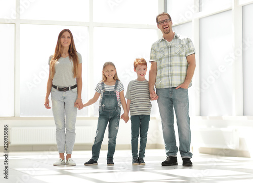 modern family standing in a new apartment