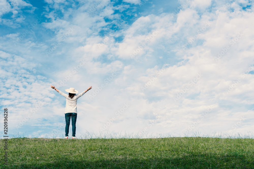 Standing woman raised her hands on the mountain, natural green and beautiful sky. Standing woman raised her hands on the mountain, natural green and beautiful sky.