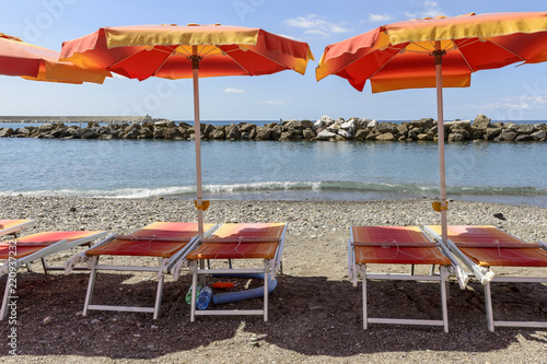 deck chairs and beach umbrellas at beach resort, Chiavari, Italy