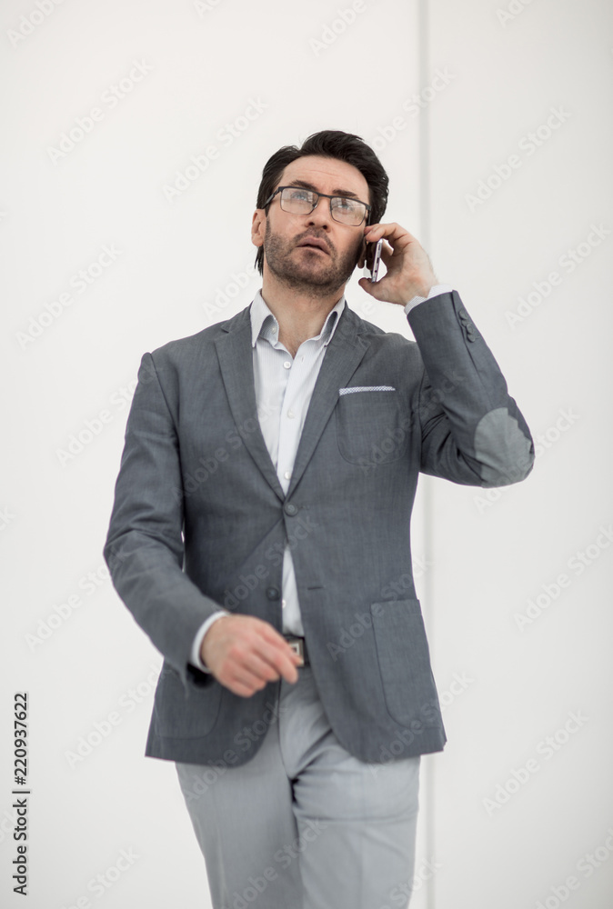 serious businessman talking on a smartphone serious businessman talking on a smartphone