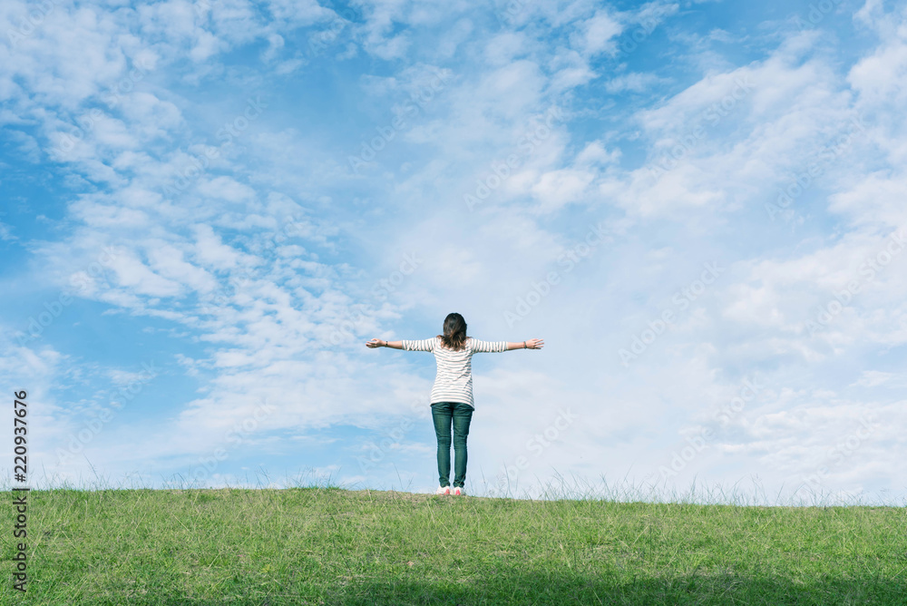 Standing woman raised her hands on the mountain, natural green and beautiful sky. Standing woman raised her hands on the mountain, natural green and beautiful sky.