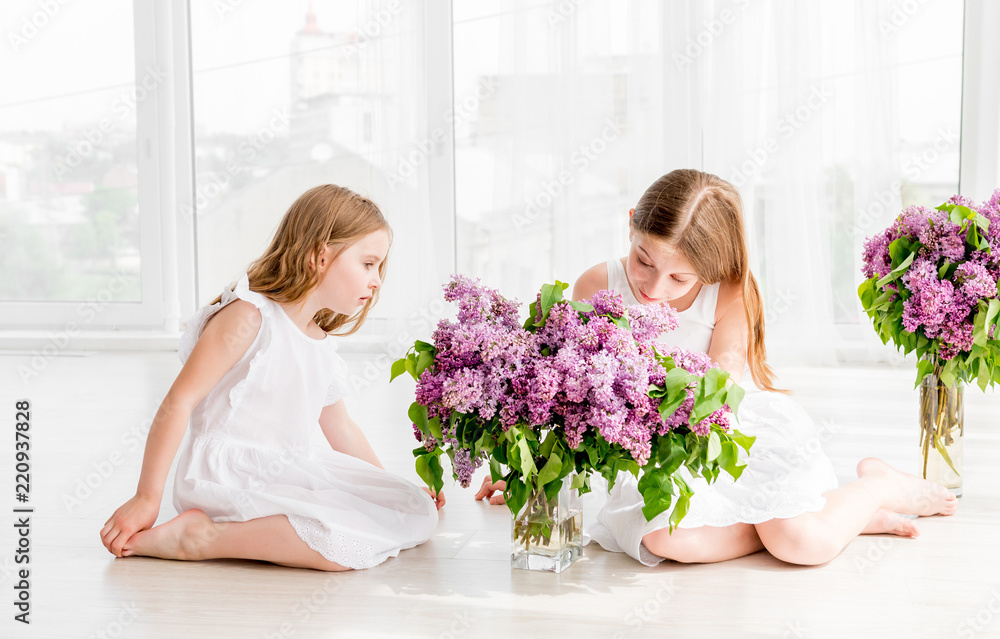 Smiling child girls with lilac bouquet Smiling child girls with lilac bouquet
