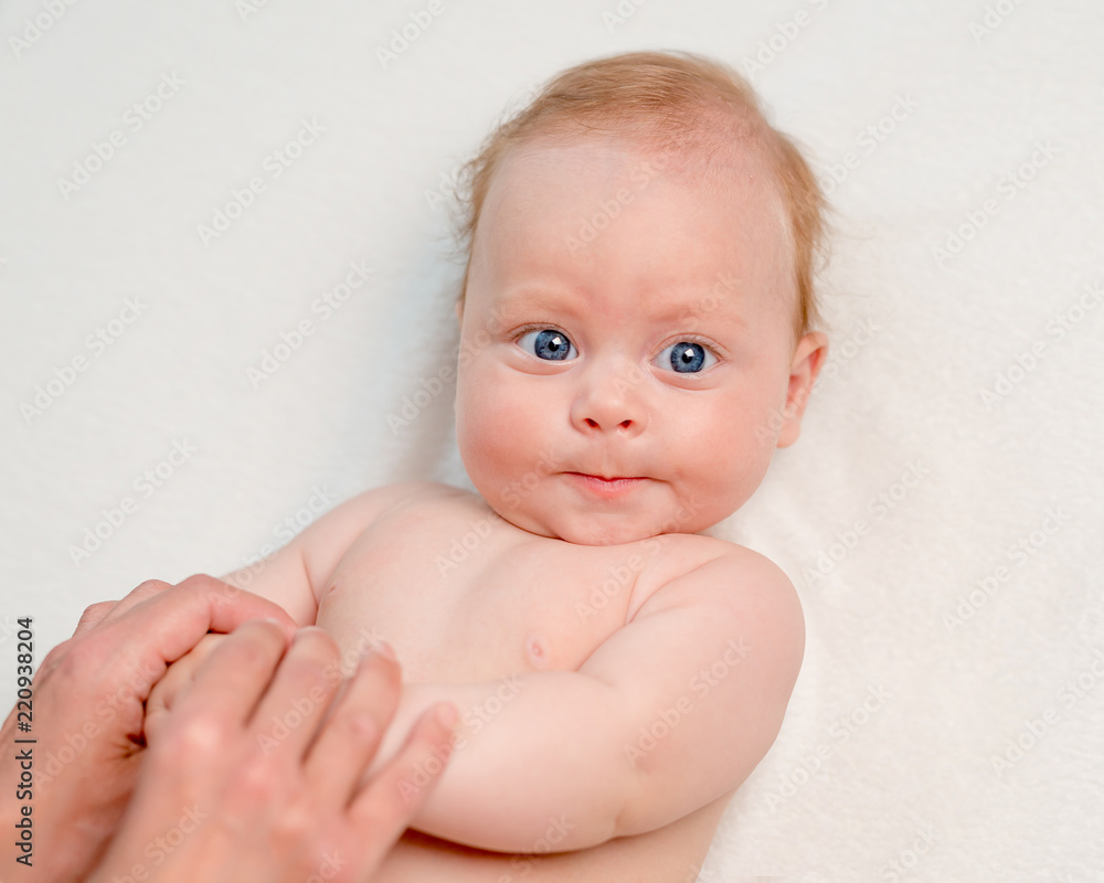 Mother doing body massage or gymnastics for newborn Mother doing body massage or gymnastics for newborn