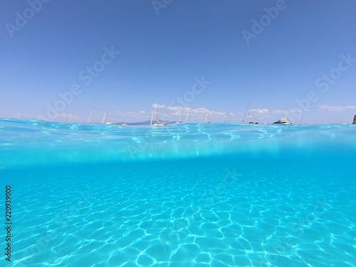 Underwater photo of tropical paradise turquoise exotic beach of Voutoumi with sail boats docked in island of Antipaxos  Ionian  Greece