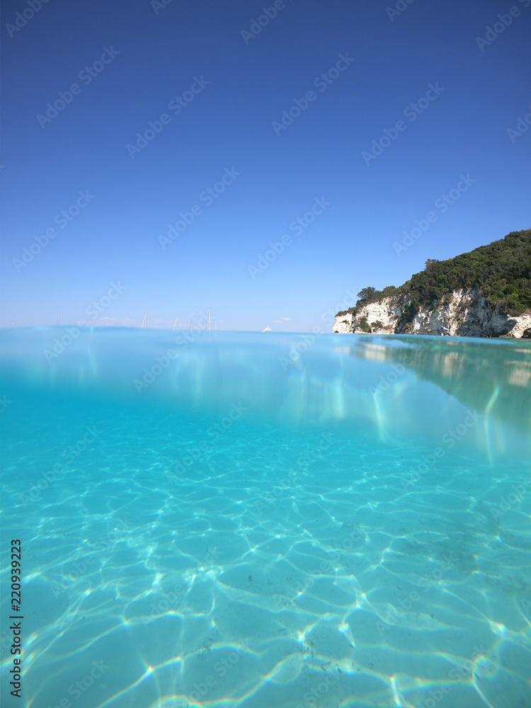 Sea level underwater photo of tropical caribbean paradise turquoise beach in exotic island located in an ocean Sea level underwater photo of tropical caribbean paradise turquoise beach in exotic island located in an ocean