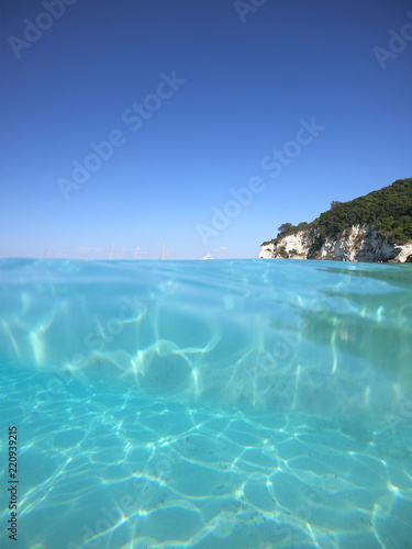 Sea level underwater photo of tropical caribbean paradise turquoise beach in exotic island located in an ocean