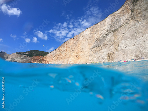 Sea level underwater photo of tropical caribbean paradise turquoise beach in exotic island located in an ocean