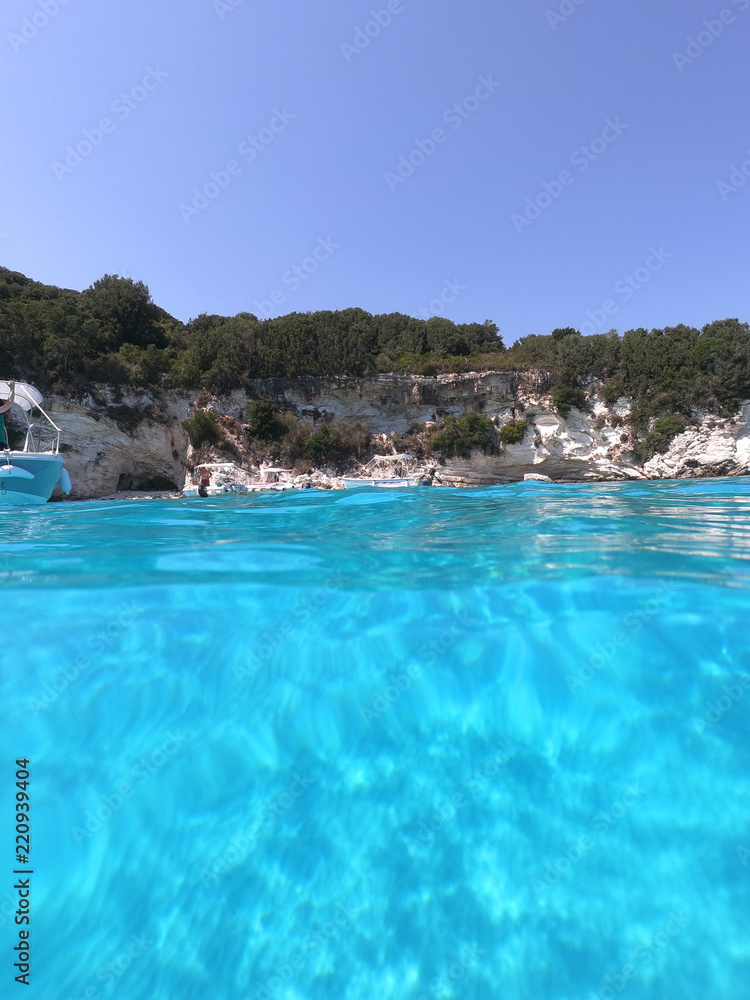 Sea level underwater photo of tropical caribbean paradise turquoise beach in exotic island located in an ocean
