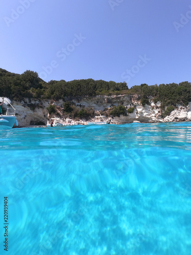 Sea level underwater photo of tropical caribbean paradise turquoise beach in exotic island located in an ocean