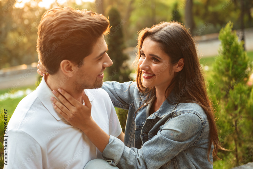 Loving couple walking outdoors while hugging. Loving couple walking outdoors while hugging.