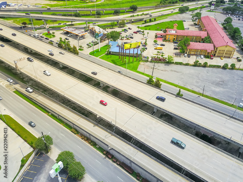 Aerial view highway 90 (U.S. Route 90, US-90) and elevated Westbank expressway in suburban New Orleans. Massive intersection, stack interchange, road junction overpass in daytime photo