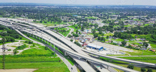 Panorama aerial view highway 90 (U.S. Route 90, US-90) and elevated Westbank expressway in suburban New Orleans, Louisiana. Massive intersection, stack interchange, road junction overpass with traffic