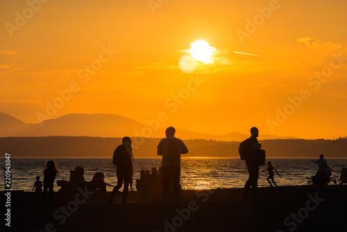 scene view of silhouette people on the beach with sunset on summer Seattle usa.