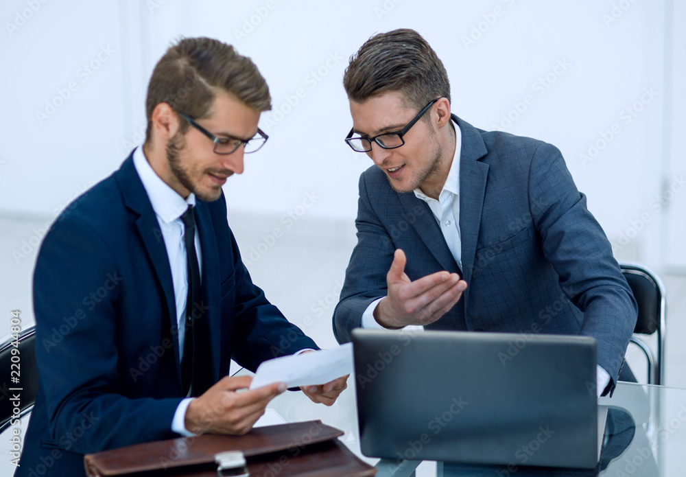 close up.two business men discussing a business document close up.two business men discussing a business document