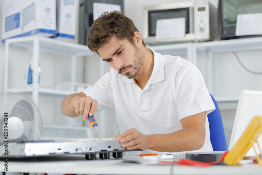 man installing induction hobs in a kitchen man installing induction hobs in a kitchen