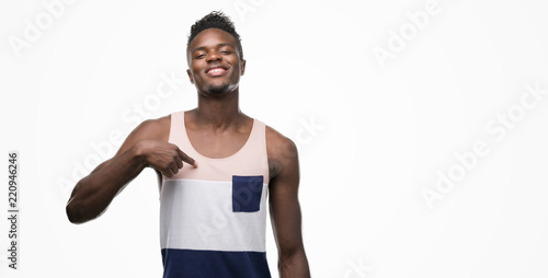 Young african american man with surprise face pointing finger to himself