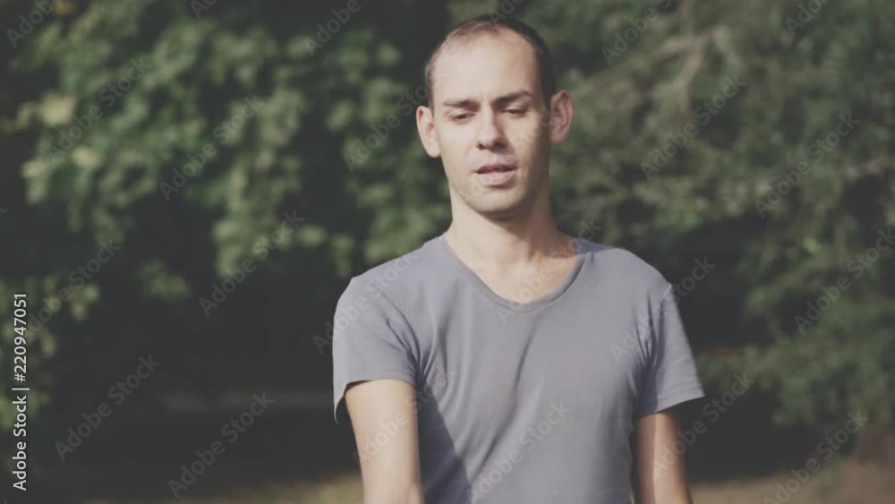 Portrait of man holding bitcoin in his hand.