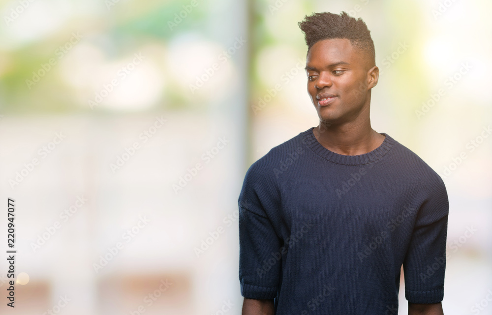 Young african american man over isolated background looking away to side with smile on face, natural expression. Laughing confident. Young african american man over isolated background looking away to side with smile on face, natural expression. Laughing confident.